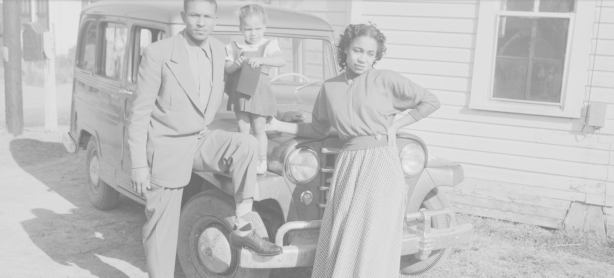 Family in front of a car