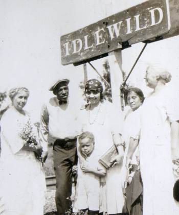 People standing in front of an Idlewild sign
